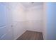 Walk-in closet with wood floors and ample storage space with shelves on all walls at 942 Village View Cir, Loganville, GA 30052
