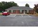 View of the community clubhouse featuring parking, manicured landscape and brick construction at 942 Village View Cir, Loganville, GA 30052