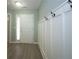 Inviting entryway with sleek wood flooring and a stylish coat rack featuring hook-style hardware at 942 Village View Cir, Loganville, GA 30052