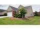 Well-maintained home exterior featuring lush green lawn, manicured shrubbery, and tidy landscaping at 942 Village View Cir, Loganville, GA 30052