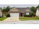 Charming single-story brick home with a manicured lawn and attached two-car garage at 942 Village View Cir, Loganville, GA 30052