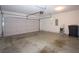 Spacious two car garage with ample room for parking and storage, overhead door and cement floors at 942 Village View Cir, Loganville, GA 30052