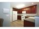 Well-equipped kitchen with cherry cabinets, laminate countertops and white appliances at 942 Village View Cir, Loganville, GA 30052