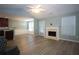 Spacious living room featuring hardwood floors, a fireplace, and natural light at 942 Village View Cir, Loganville, GA 30052