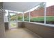 Inside of the sunroom, view of backyard with retaining wall and green landscape through the screen at 942 Village View Cir, Loganville, GA 30052