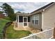 A charming sunroom addition is visible from the exterior of this house featuring a serene landscape at 942 Village View Cir, Loganville, GA 30052
