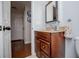 Bathroom vanity with cabinet, granite counter, and decorative mirror at 97 Coral Dr, Whitesburg, GA 30185