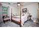 Charming bedroom featuring a four poster bed, soft colors, and art decor at 97 Coral Dr, Whitesburg, GA 30185