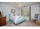 Cozy bedroom featuring a metal bed frame, carpeting, and overhead fan at 97 Coral Dr, Whitesburg, GA 30185