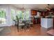 Bright dining area with a glass table set and ample natural light, adjacent to the kitchen at 97 Coral Dr, Whitesburg, GA 30185