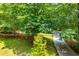 Wide driveway leading to a home surrounded by mature trees and landscaping at 97 Coral Dr, Whitesburg, GA 30185