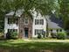 Beautiful exterior view of home featuring stone facade, symmetrical windows and a landscaped yard at 97 Coral Dr, Whitesburg, GA 30185