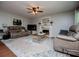 Cozy living room with a fireplace, plush sofas and a ceiling fan, perfect for relaxation at 97 Coral Dr, Whitesburg, GA 30185
