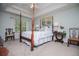 Spacious main bedroom featuring a four-poster bed and a tray ceiling at 97 Coral Dr, Whitesburg, GA 30185