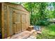 Wooden storage shed with double doors, and surrounded by natural beauty at 97 Coral Dr, Whitesburg, GA 30185