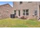 A small backyard with a patio and table/chairs sits outside a unit's ground floor door at 10151 Benton Woods Dr, Covington, GA 30014