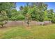 A large backyard with a wood fence on the back perimeter of the property at 10151 Benton Woods Dr, Covington, GA 30014