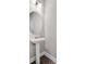 Elegant pedestal sink in bathroom with brushed nickel faucet and modern lighting fixture at 10151 Benton Woods Dr, Covington, GA 30014