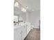 Bright bathroom with white cabinetry, dual sinks, a large mirror and recessed lighting at 10151 Benton Woods Dr, Covington, GA 30014