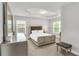 Bright bedroom featuring tray ceilings, neutral decor, carpet and a king size bed at 10151 Benton Woods Dr, Covington, GA 30014