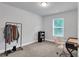 Bedroom with carpeted floors, neutral paint, natural light, desk, and modern chair at 10151 Benton Woods Dr, Covington, GA 30014