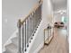 Inviting entryway features a staircase with black iron railing and modern decor at 10151 Benton Woods Dr, Covington, GA 30014
