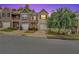Charming townhome showcasing brick facade, attached garages, and a beautifully landscaped front yard at 10151 Benton Woods Dr, Covington, GA 30014