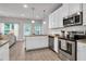 Bright kitchen features stainless steel appliances, granite countertops, and an open layout at 10151 Benton Woods Dr, Covington, GA 30014