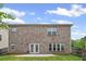 Exterior shot of brick home and backyard with concrete patio at 29 Lankford Rd, Tucker, GA 30084