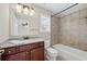 Bright bathroom featuring a vanity with granite countertop, shower/tub combo, and neutral tiling for a clean look at 29 Lankford Rd, Tucker, GA 30084