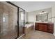 Bright bathroom featuring a separate shower and tub, complemented by a dark wood vanity and neutral tiling at 29 Lankford Rd, Tucker, GA 30084
