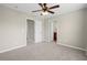 Neutral bedroom with carpet, ceiling fan, and two doors, creating a serene and functional living space at 29 Lankford Rd, Tucker, GA 30084