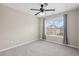 Bright carpeted bedroom with a window, ceiling fan, and curtains, creating a comfortable and inviting atmosphere at 29 Lankford Rd, Tucker, GA 30084
