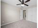 Neutral carpeted bedroom featuring a ceiling fan and double doors, providing a comfortable and functional space at 29 Lankford Rd, Tucker, GA 30084
