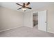 Neutral carpeted bedroom with ceiling fan and entry door, providing a cozy and functional living space at 29 Lankford Rd, Tucker, GA 30084