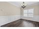 Elegant dining room showcasing wainscoting, tray ceiling, and a stylish chandelier, perfect for formal gatherings at 29 Lankford Rd, Tucker, GA 30084