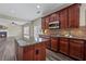 Beautiful kitchen with island, stainless appliances, and granite countertops open to the living area at 29 Lankford Rd, Tucker, GA 30084
