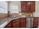 Well-equipped kitchen featuring granite countertops, stainless steel appliances, and tile backsplash at 29 Lankford Rd, Tucker, GA 30084