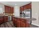 Well-equipped kitchen with dark wood cabinets, granite countertops, and stainless steel appliances, a chef's delight at 29 Lankford Rd, Tucker, GA 30084