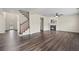 Open-concept living area featuring wood-look floors, staircase, and fireplace, ideal for relaxation and gatherings at 29 Lankford Rd, Tucker, GA 30084
