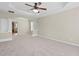 Spacious main bedroom with a tray ceiling, windows, and doorway to an ensuite bathroom at 29 Lankford Rd, Tucker, GA 30084