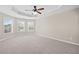 Large carpeted main bedroom with a tray ceiling and plenty of natural light at 29 Lankford Rd, Tucker, GA 30084