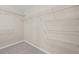 Spacious walk-in closet with wall-mounted white wire shelving and neutral carpeting, providing ample storage at 29 Lankford Rd, Tucker, GA 30084