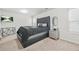 Bright bedroom featuring a diamond-tufted headboard, modern side table and decor, and a wall-mounted television at 4076 Sonoma Wood Trl, Decatur, GA 30034