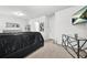 A bedroom featuring neutral walls, a sleek black bed set, and minimalist decor for a modern touch at 4076 Sonoma Wood Trl, Decatur, GA 30034