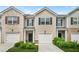 Traditional townhome featuring neutral siding, a one-car garage, and manicured landscaping at 4076 Sonoma Wood Trl, Decatur, GA 30034
