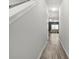 Hallway with wood floors leading to a bright living area, creating an inviting flow at 4076 Sonoma Wood Trl, Decatur, GA 30034