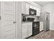 Modern kitchen features stainless steel appliances, white cabinets, and granite countertops at 4076 Sonoma Wood Trl, Decatur, GA 30034