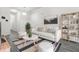 Bright living room with a white sofa, stylish rug, and ample natural light at 4076 Sonoma Wood Trl, Decatur, GA 30034