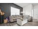 Modern living room with a comfortable gray sofa, a decorative accent wall, and sleek wood floors at 4076 Sonoma Wood Trl, Decatur, GA 30034